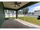View of the screened in patio with an outdoor ceiling fan and view of the fenced in yard at 4154 Duluth Ter, North Port, FL 34286