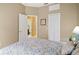 Inviting bedroom with a view of an ensuite bathroom and a closet, offering comfort and convenience at 3203 Sago Point Ct, Land O Lakes, FL 34639