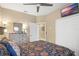 Bedroom featuring a mounted TV, a dresser, a closet, and an ensuite bathroom at 3203 Sago Point Ct, Land O Lakes, FL 34639