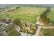 This is an aerial view of a golf course featuring a driving range, putting greens and a miniature golf course at 3203 Sago Point Ct, Land O Lakes, FL 34639