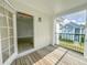 Balcony with wood flooring and wrought iron railings overlooking a building in the community at 4007 Bangalow Palm Ct # 4007, Tampa, FL 33624
