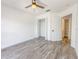 Bright bedroom featuring wood-look floors, ceiling fan, closet and access to an ensuite bathroom at 4007 Bangalow Palm Ct # 4007, Tampa, FL 33624