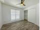 Bedroom featuring neutral walls, wood-look floors, and a closet at 4007 Bangalow Palm Ct # 4007, Tampa, FL 33624