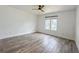 Bedroom with a ceiling fan, laminate flooring, and a window with natural light at 4007 Bangalow Palm Ct # 4007, Tampa, FL 33624