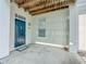 Covered entrance with dark teal door, white columns and a view of the wooden ceiling above at 4007 Bangalow Palm Ct # 4007, Tampa, FL 33624