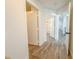 Hallway with multiple doorways including one to a bathroom with a tub and shower at 4007 Bangalow Palm Ct # 4007, Tampa, FL 33624