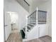 Elegant staircase with dark metal railing and white wooden posts leading to the second floor at 4007 Bangalow Palm Ct # 4007, Tampa, FL 33624