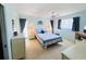 Inviting primary bedroom with soft, blue walls, carpeted floors, ceiling fan, and natural light at 933 Harbor S Dr, Venice, FL 34285