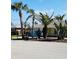 Charming single-story home with a well-manicured lawn and mature palm trees enhancing curb appeal at 933 Harbor S Dr, Venice, FL 34285