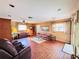 Spacious living room featuring unique flooring, neutral colored walls, and lots of natural light from two windows at 933 Harbor S Dr, Venice, FL 34285