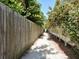 Picturesque walking path bordered by lush greenery, leading to the beach and crystal clear waters at 933 Harbor S Dr, Venice, FL 34285