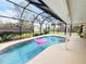 A screened in swimming pool, patio, fenced yard, and privacy landscaping at 933 Harbor S Dr, Venice, FL 34285