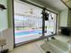 View from the kitchen sink to the screen enclosed pool and lanai at 933 Harbor S Dr, Venice, FL 34285