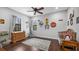 Bedroom featuring hardwood floors, ceiling fan, and two windows at 15734 Old Mill Pond Rd, Dade City, FL 33523