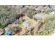 Aerial view of a single-story house and large lot with a parcel outline on the land at 33021 Ranch Rd, Dade City, FL 33523