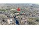 Aerial perspective of home, featuring the nearby river and lush natural surroundings at 33021 Ranch Rd, Dade City, FL 33523
