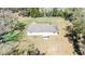 Overhead aerial view of a single-story house with a long driveway on a parcel with trees and other vegetation at 33021 Ranch Rd, Dade City, FL 33523