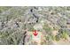 Aerial view of a single-story home on a large parcel of land surrounded by vegetation and trees at 33021 Ranch Rd, Dade City, FL 33523