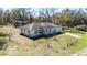 Aerial view of the single-Gathering home surrounded by a lush green yard at 33021 Ranch Rd, Dade City, FL 33523