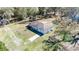 Aerial view of a single-story house with a long driveway surrounded by trees and vegetation at 33021 Ranch Rd, Dade City, FL 33523