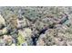 An aerial view of a single-story house on a large parcel of land with a red outline at 33021 Ranch Rd, Dade City, FL 33523