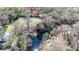 Aerial view of a property showcasing its proximity to a beautiful creek and surrounding landscape at 33021 Ranch Rd, Dade City, FL 33523