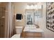 Well-lit bathroom with a decorative mirror, white marble countertop, and neutral colored walls at 33021 Ranch Rd, Dade City, FL 33523