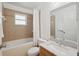Bathroom featuring a shower, bathtub, and marble countertop sink at 33021 Ranch Rd, Dade City, FL 33523