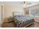 Comfortable bedroom with wood floors, natural light, and a queen bed with patterned bedding at 33021 Ranch Rd, Dade City, FL 33523