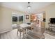 Light and airy dining area with neutral walls, a sliding glass door to the backyard, and a connecting open kitchen at 33021 Ranch Rd, Dade City, FL 33523