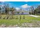This is a front exterior view of a white house with a well-maintained lawn and driveway at 33021 Ranch Rd, Dade City, FL 33523