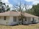 Cozy single-story home featuring a well-maintained lawn and a classic ranch-style facade at 33021 Ranch Rd, Dade City, FL 33523