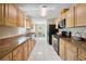 Spacious kitchen with granite countertops, stainless steel appliances, and white tile flooring at 33021 Ranch Rd, Dade City, FL 33523