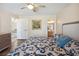 Comfortable main bedroom featuring a decorative ceiling fan, ensuite bathroom, and a relaxing atmosphere at 33021 Ranch Rd, Dade City, FL 33523
