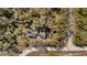Aerial view of a home nestled among trees with visible road access and a large lot at 7157 Knoxville Dr, Webster, FL 33597