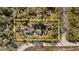 An aerial shot of the house surrounded by a border in the middle of woodland at 7157 Knoxville Dr, Webster, FL 33597