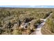 Aerial view of home with mature trees, landscaping, and driveway access at 7157 Knoxville Dr, Webster, FL 33597