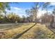 Large backyard featuring a gazebo, lush green grass, and mature trees at 7157 Knoxville Dr, Webster, FL 33597