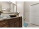 Bathroom featuring a dark wood vanity with a bowl sink and a large framed mirror at 7157 Knoxville Dr, Webster, FL 33597