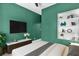 Stylized bedroom featuring a large flat screen TV, sleek furnishings, and a built-in bookshelf at 7157 Knoxville Dr, Webster, FL 33597