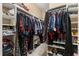 Walk-in closet with built-in shelving and racks filled with clothing and shoes at 7157 Knoxville Dr, Webster, FL 33597