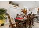 Dining room with a wooden table, six chairs, and views into the kitchen area at 7157 Knoxville Dr, Webster, FL 33597