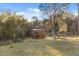 View of the wooden gazebo surrounded by trees and lush green grass at 7157 Knoxville Dr, Webster, FL 33597