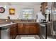 Well-appointed kitchen featuring stainless steel appliances, granite countertops, and wooden cabinets at 7157 Knoxville Dr, Webster, FL 33597