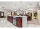 Open-concept kitchen with a large island and stainless steel appliances, seamlessly connecting to the dining area at 7157 Knoxville Dr, Webster, FL 33597