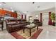 Cozy living room featuring a leather sofa, coffee table, and natural light from the windows at 7157 Knoxville Dr, Webster, FL 33597