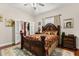 Spacious main bedroom with a decorative bed frame, plush bedding, and natural light at 7157 Knoxville Dr, Webster, FL 33597