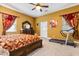 The primary bedroom features red curtains, dresser with mirror, and a treadmill at 7157 Knoxville Dr, Webster, FL 33597