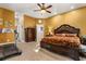 Spacious bedroom with a decorative wood bed frame, a treadmill, and carpeted floors at 7157 Knoxville Dr, Webster, FL 33597