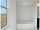 Bright bathroom showcases a white tub with marble-style tile and a window at 196 Eagleston Ln, Lakewood Ranch, FL 34240